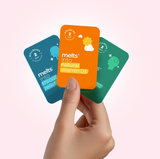 A hand holding an assortment of Melts for throat relief, natural vitamin D3, and vegan vitamin B12